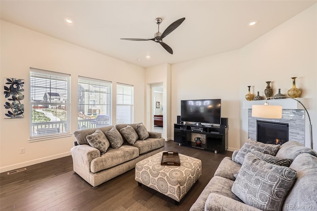 14521 Vancouver Pl, Parker, CO 80134 - living room with dark wood-style flooring, ceiling fan, a tiled fireplace, and baseboards