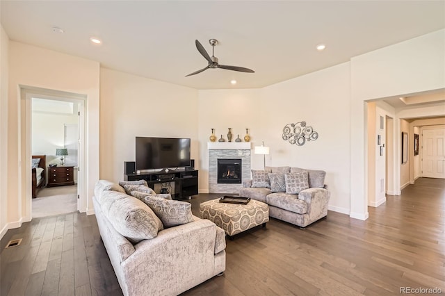 14521 Vancouver Pl, Parker, CO 80134 - living area featuring dark wood-type flooring, ceiling fan, baseboards, and a stone fireplace
