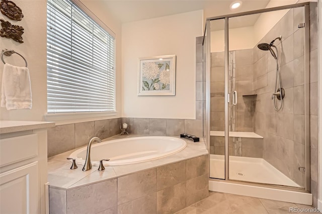 14521 Vancouver Pl, Parker, CO 80134 - full bath featuring tile patterned floors, a bath, a shower stall, and plenty of natural light