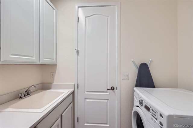 14521 Vancouver Pl, Parker, CO 80134 - washroom with washer and dryer, a sink, and cabinet space