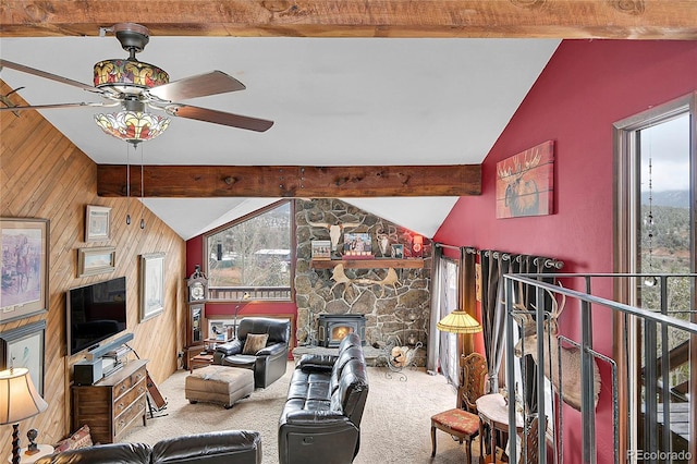 living room with carpet floors, lofted ceiling with beams, wooden walls, and ceiling fan