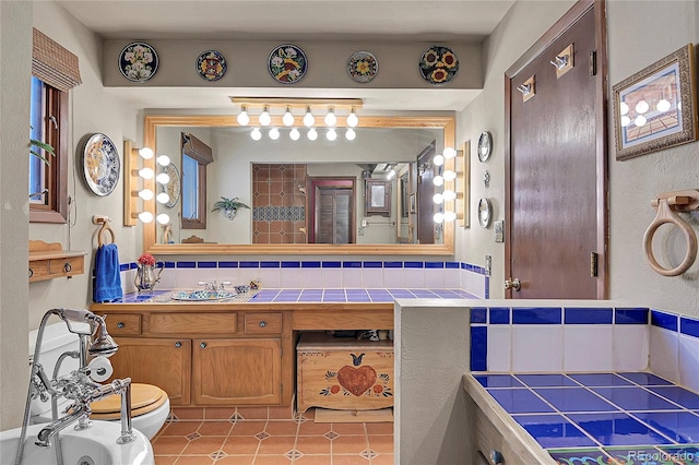 bathroom with vanity, backsplash, tile patterned floors, and toilet