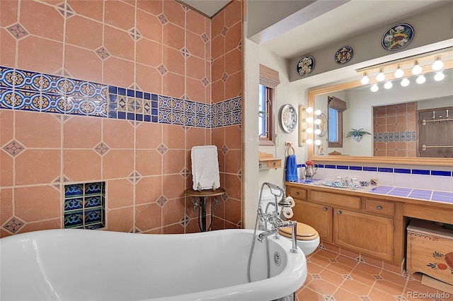 bathroom with tasteful backsplash, vanity, a tub, and toilet