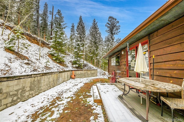 snowy yard with a deck