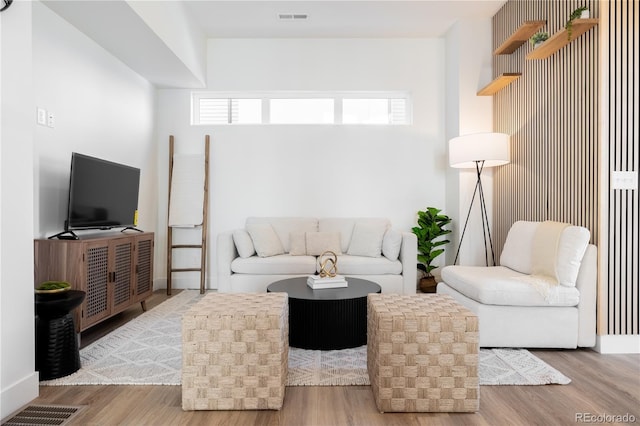 living room with visible vents and wood finished floors