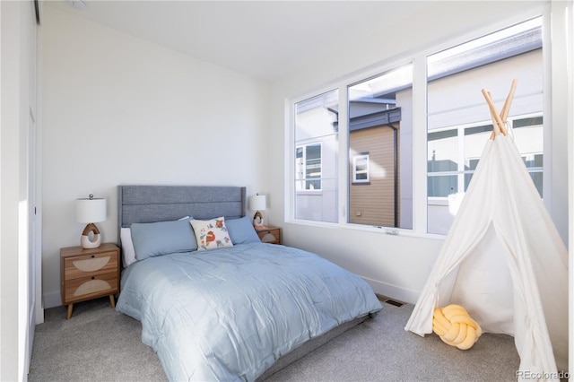 carpeted bedroom featuring baseboards