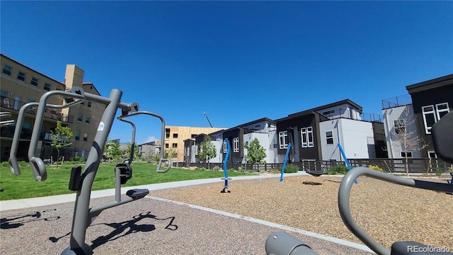 community playground featuring a residential view and a lawn