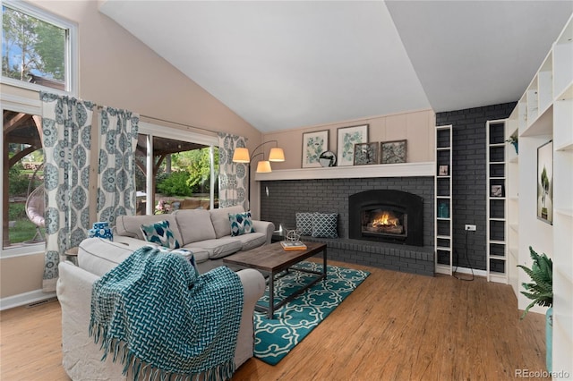 6621 E Peakview Pl, Centennial, CO 80111 - living area with wood finished floors, a fireplace, vaulted ceiling, and baseboards