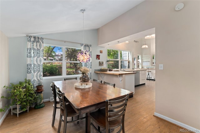 6621 E Peakview Pl, Centennial, CO 80111 - dining room featuring vaulted ceiling, light wood-style floors, baseboards, and healthy amount of natural light