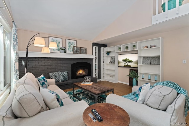 6621 E Peakview Pl, Centennial, CO 80111 - living area with wood finished floors, vaulted ceiling, and a fireplace