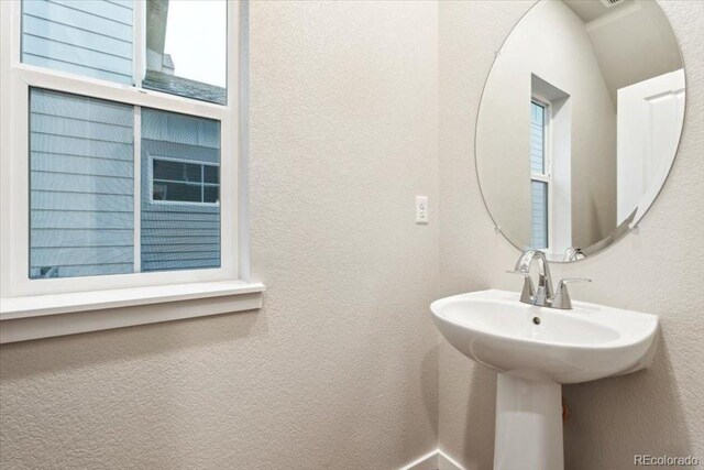 19019 E 94th Pl, Commerce City, CO 80022 - bathroom with a textured wall and a sink