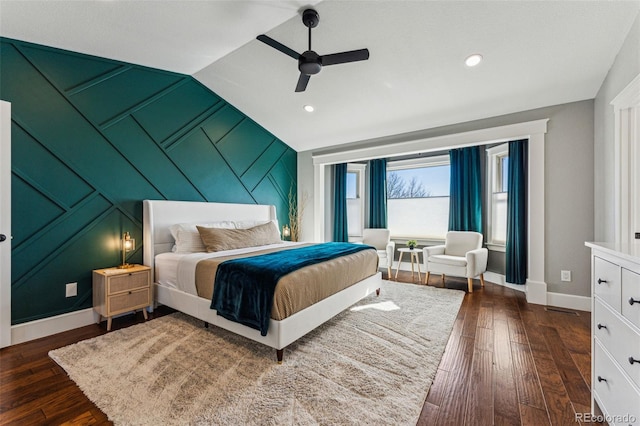 bedroom featuring dark wood-style floors, baseboards, vaulted ceiling, and a ceiling fan