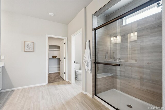 5142 N Quemoy Ct, Aurora, CO 80019 - full bathroom with toilet, a stall shower, vanity, and baseboards