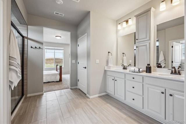 5142 N Quemoy Ct, Aurora, CO 80019 - full bathroom featuring double vanity, ensuite bath, baseboards, and a shower with shower door