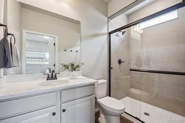 5142 N Quemoy Ct, Aurora, CO 80019 - bathroom featuring toilet, a shower stall, and vanity