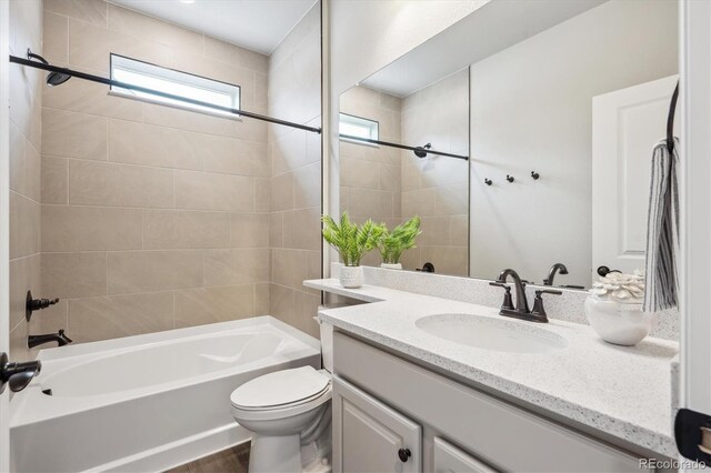 5142 N Quemoy Ct, Aurora, CO 80019 - bathroom with vanity,  shower combination, and toilet