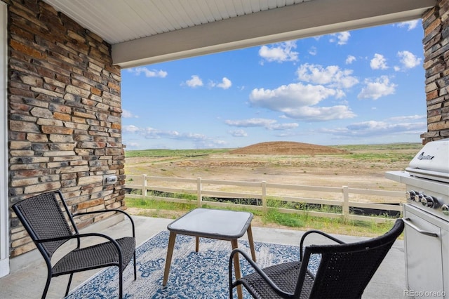 5142 N Quemoy Ct, Aurora, CO 80019 - view of patio / terrace with a rural view and a grill