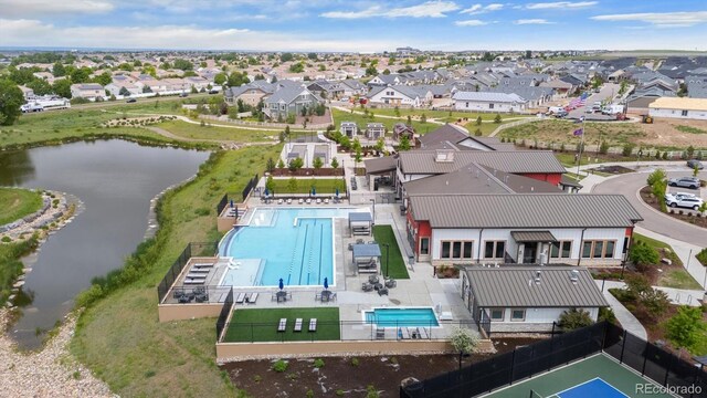5142 N Quemoy Ct, Aurora, CO 80019 - aerial perspective of suburban area with a pool and a large body of water