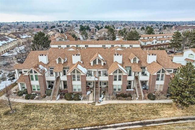 view of front facade with stairs, a residential view, and a front lawn