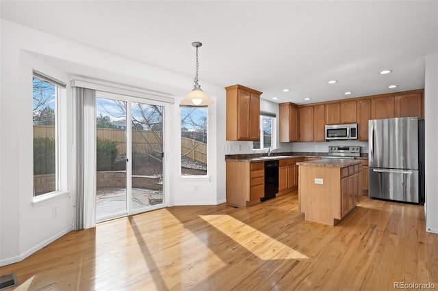 kitchen featuring a wealth of natural light, light wood-style floors, and appliances with stainless steel finishes