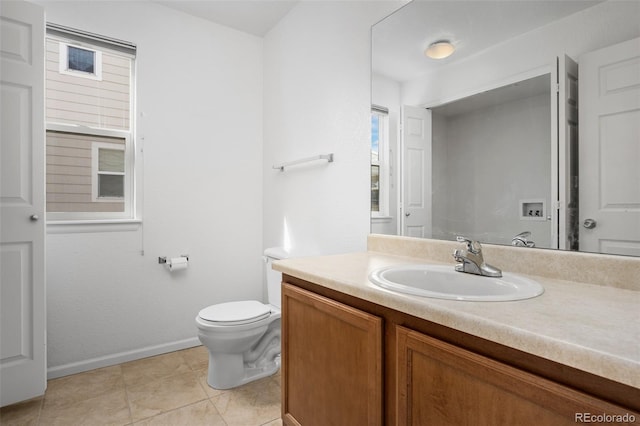 bathroom featuring tile patterned flooring, toilet, vanity, and baseboards