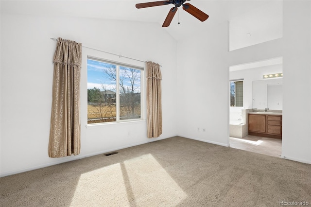 unfurnished bedroom with visible vents, carpet flooring, ensuite bath, and a sink