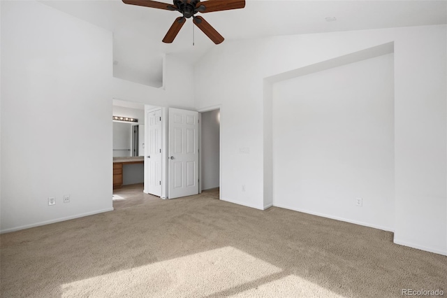 unfurnished bedroom featuring baseboards, ensuite bathroom, high vaulted ceiling, and carpet flooring