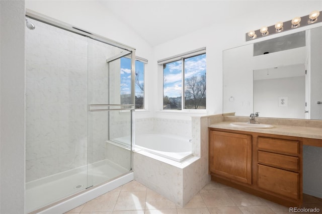 bathroom with a garden tub, a shower stall, tile patterned flooring, vanity, and vaulted ceiling