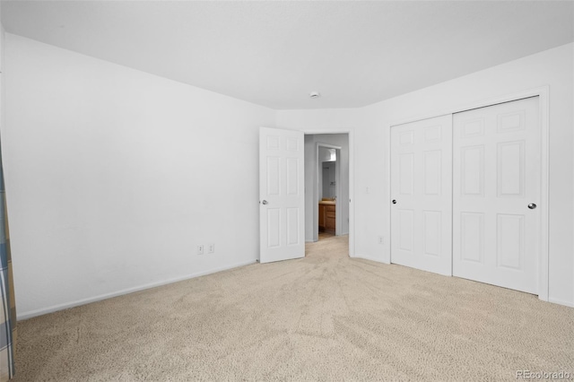 unfurnished bedroom with a closet and carpet floors