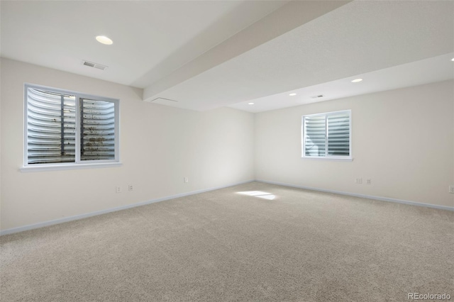 carpeted spare room with recessed lighting, visible vents, and baseboards