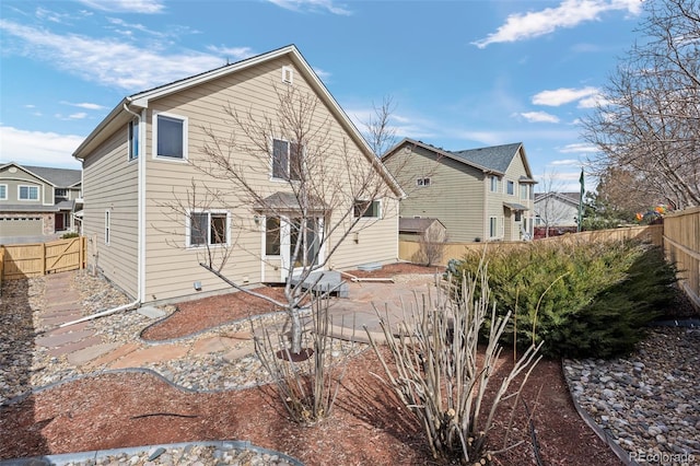 rear view of property with a patio area and a fenced backyard