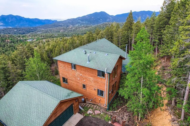 11876 Coal Creek Heights Dr, Golden, CO 80403 - view from above of property featuring a heavily wooded area and a mountain backdrop