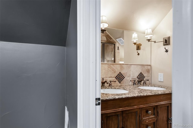 bathroom with visible vents, a sink, decorative backsplash, and a stall shower