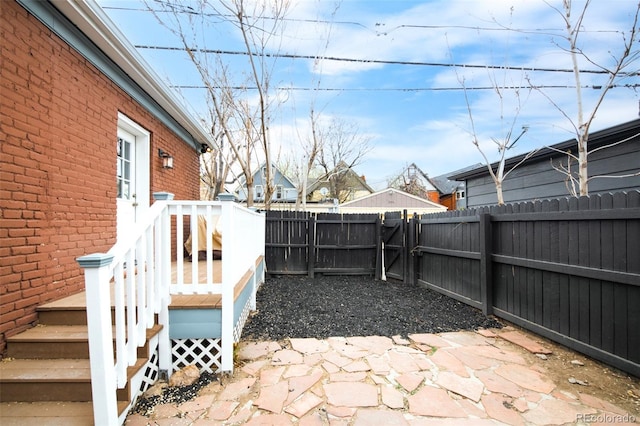 view of patio / terrace with a fenced backyard, a gate, and a deck