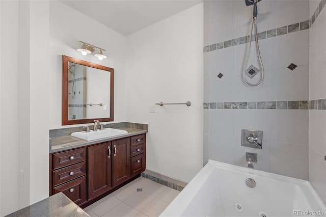 bathroom with tile patterned flooring, a jetted tub, and vanity