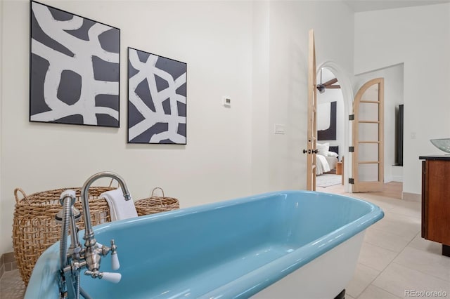 ensuite bathroom with a freestanding bath, connected bathroom, vanity, and tile patterned floors