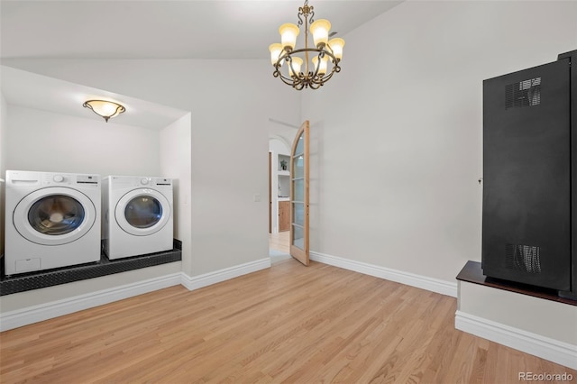 laundry area with light wood-style floors, washer and dryer, baseboards, and an inviting chandelier