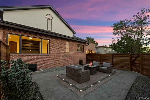 view of patio with a fire pit and fence