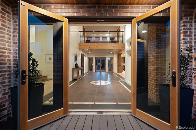 view of exterior entry featuring french doors and a balcony