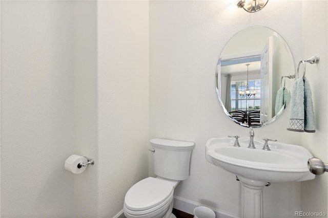 2490 Sagebrush St, Parker, CO 80138 - half bath with toilet and a chandelier