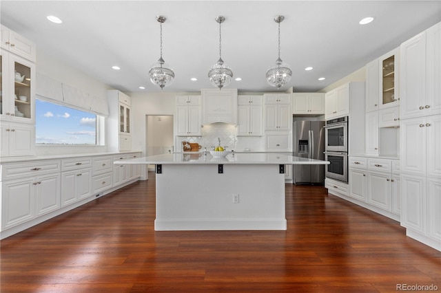 2490 Sagebrush St, Parker, CO 80138 - kitchen with stainless steel appliances, recessed lighting, light countertops, a center island, and a kitchen breakfast bar