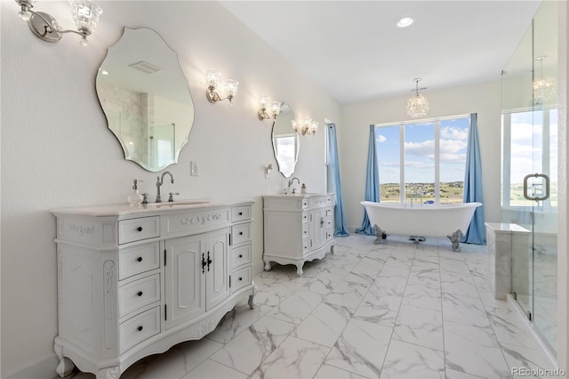 2490 Sagebrush St, Parker, CO 80138 - full bathroom with a chandelier, two vanities, a freestanding tub, marble finish floors, and recessed lighting
