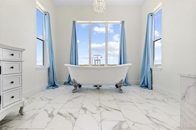 2490 Sagebrush St, Parker, CO 80138 - bathroom with a freestanding bath, plenty of natural light, and a chandelier