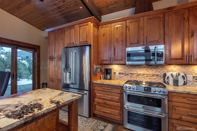 kitchen with french doors, tasteful backsplash, light stone counters, lofted ceiling with beams, and appliances with stainless steel finishes