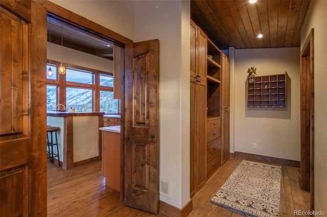 hallway featuring wood ceiling and light wood-type flooring