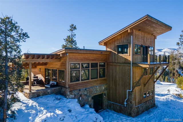 view of snow covered exterior featuring a balcony