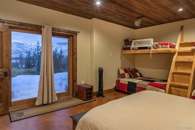 bedroom featuring a mountain view, access to exterior, and wood ceiling