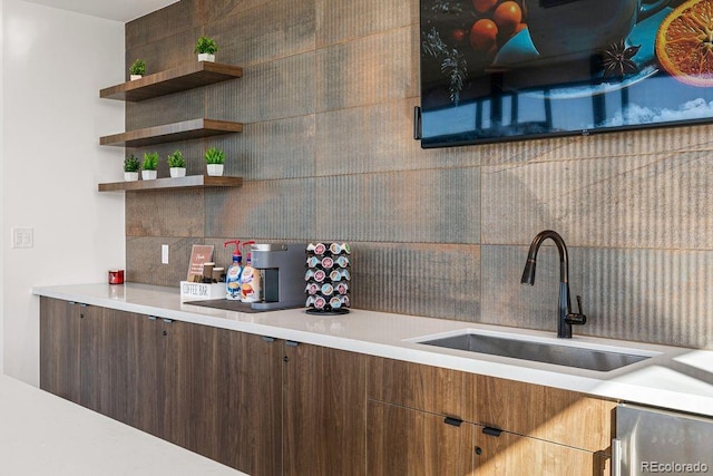 kitchen featuring backsplash, a sink, open shelves, and light countertops