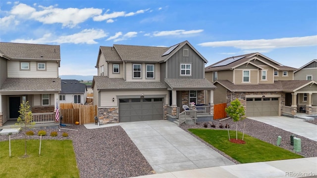 craftsman inspired home with a porch, an attached garage, board and batten siding, driveway, and stone siding