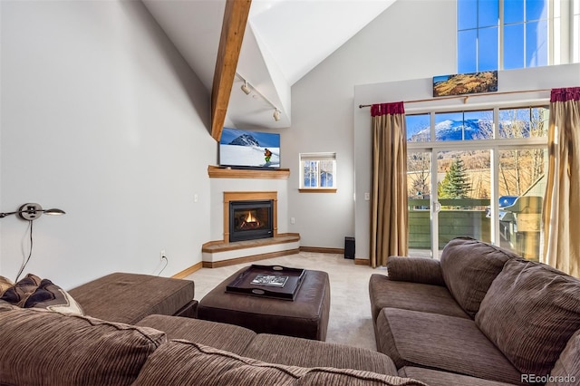 living room with beamed ceiling, high vaulted ceiling, and light colored carpet